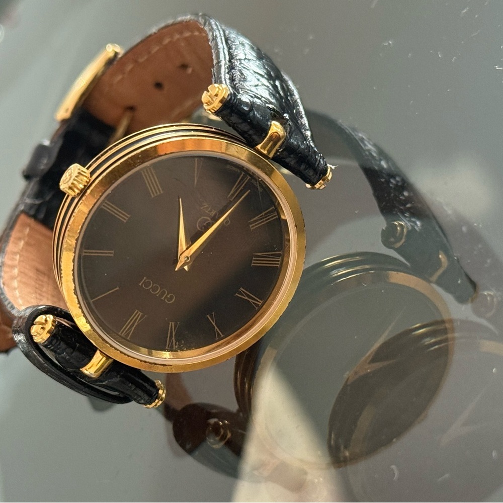 Gucci Watch with Black Dial and Gold Detailing